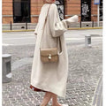 Women loose mid-length knitted cardigan in solid colour with long sleeves and pockets.