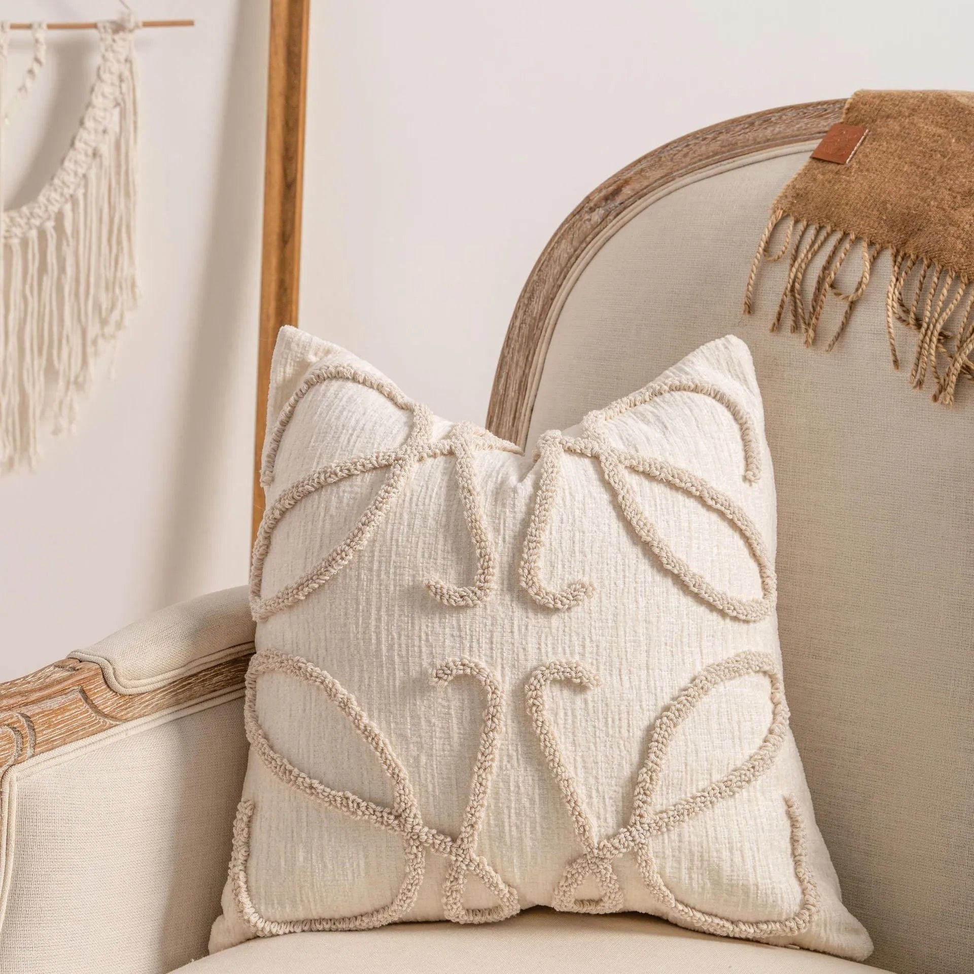 Knitted cushion cover with tassel trim in a choice of patterned designs including spiral dots and bow.