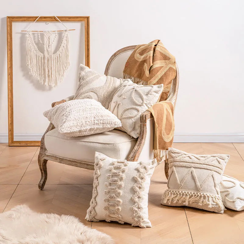 Knitted cushion cover with tassel trim in a choice of patterned designs including spiral dots and bow.