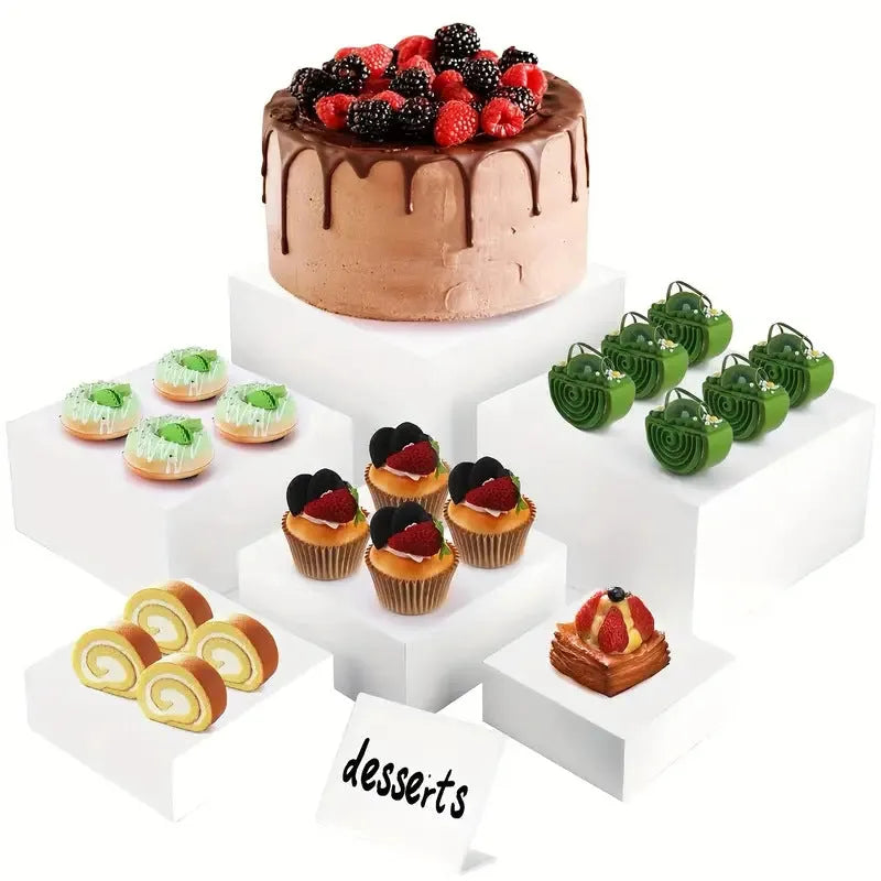 White plastic modular dessert display stand cubes stacked to form a tiered tabletop cake stand.