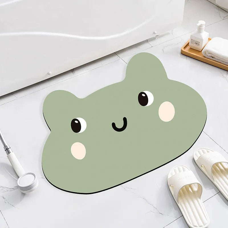 Cute cartoon animal diatomaceous earth bath mat in alien shape on bathroom floor.