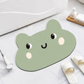 Cute cartoon animal diatomaceous earth bath mat in alien shape on bathroom floor.