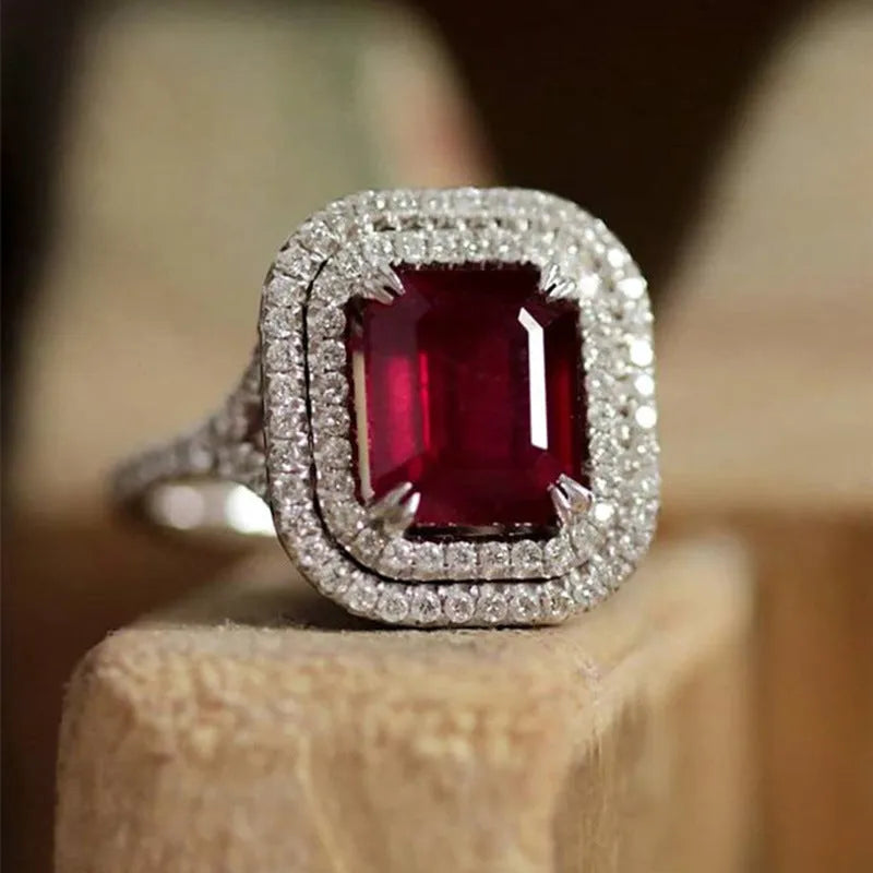 Women's square copper ring with a large red rhinestone set in a geometric princess style.