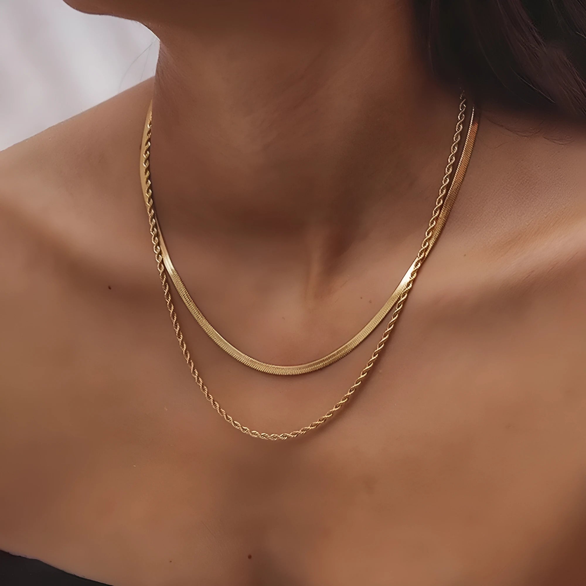 Women's geometric double-layer twist pendant necklace on an adjustable silver snake chain, shown at a mid-length setting.