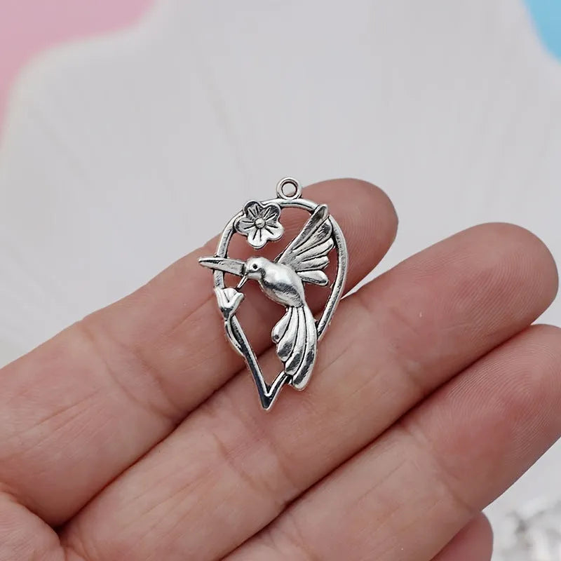 Silver-toned alloy DIY pendant with detailed magpie pattern, shown against a plain background.