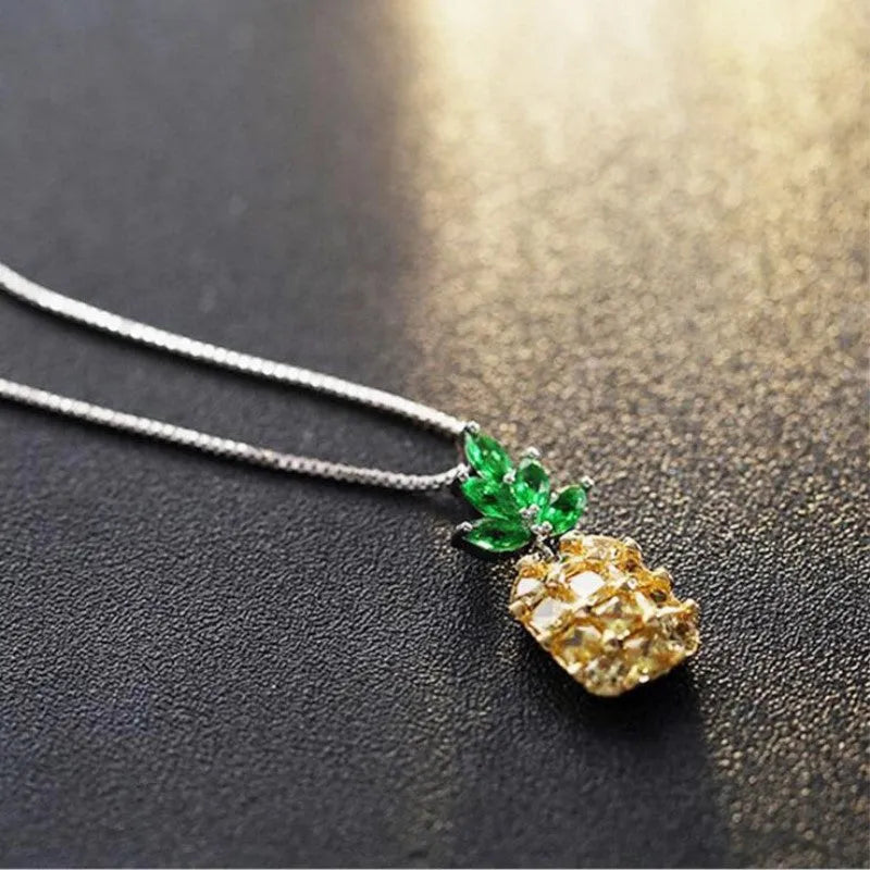 Silver coloured geometric pineapple diamond pendant necklace on a chain.