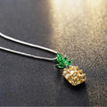 Silver coloured geometric pineapple diamond pendant necklace on a chain.
