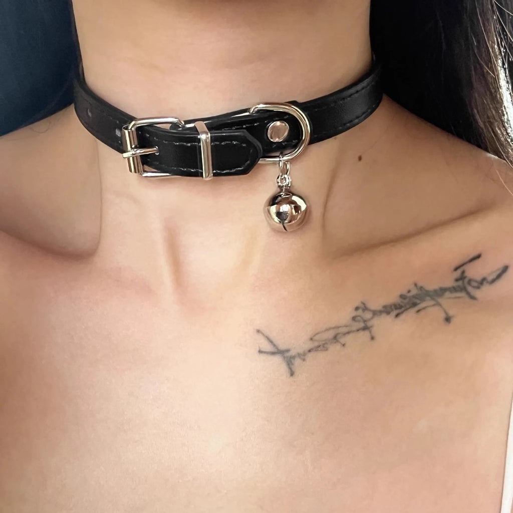 Black adjustable leather dog collar with decorative bone charm on a regular chain