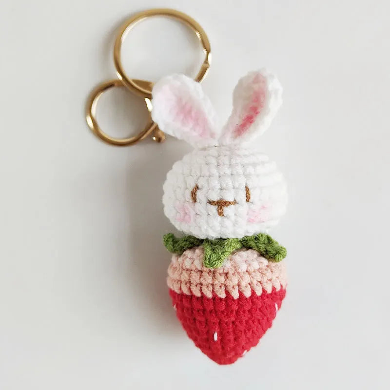 Hand-woven white rabbit strawberry cartoon charm pendant with a key attached
