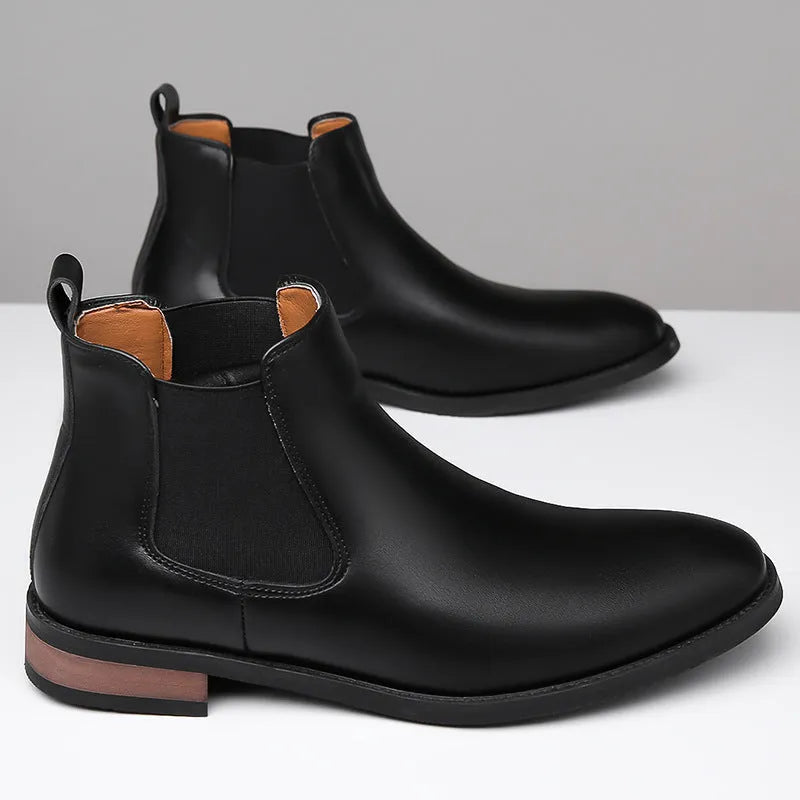 Men's black pointed toe Chelsea boots with mid-calf height and decorative stitching