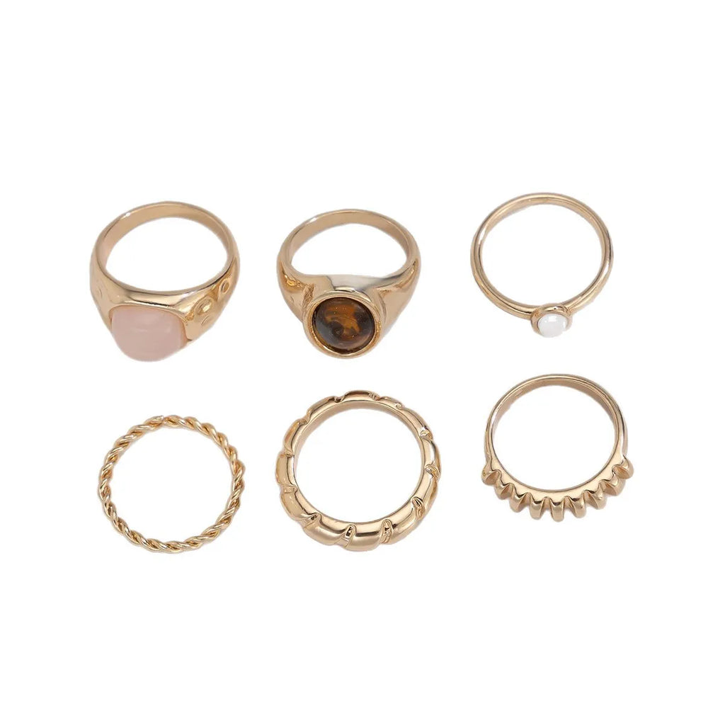 Six irregular geometric alloy rings in light gold electroplated finish arranged as jewellery set