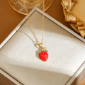 Titanium steel fashion necklace with indie cherry pendant on an O-ring chain, shown in golden colour.