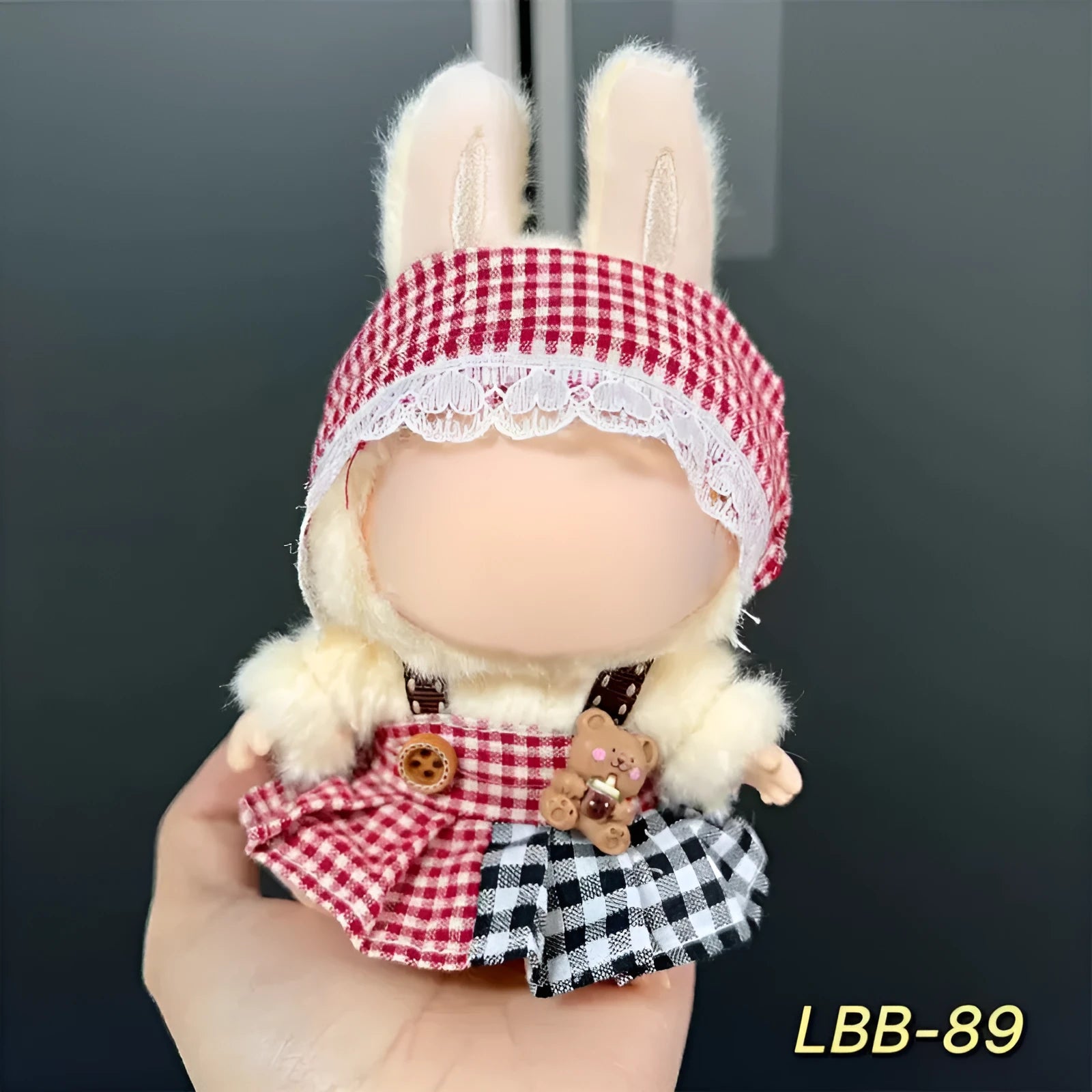 Plastic clothing outfit for a 17cm tall vinyl figure or doll on a display stand.