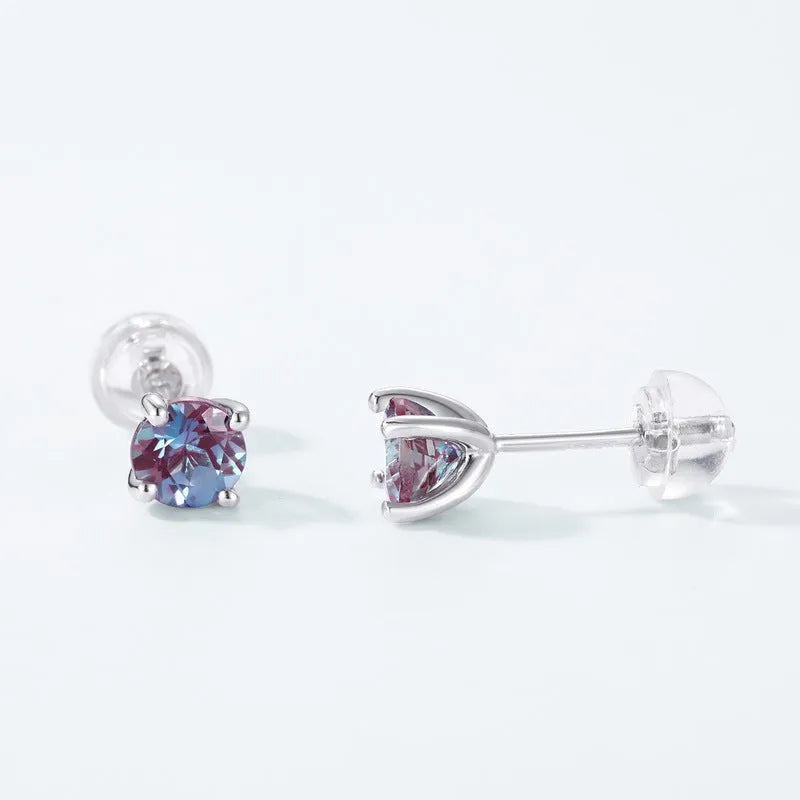 A pair of simple geometric silver ear studs with a round cultivated Alexandrite stone.