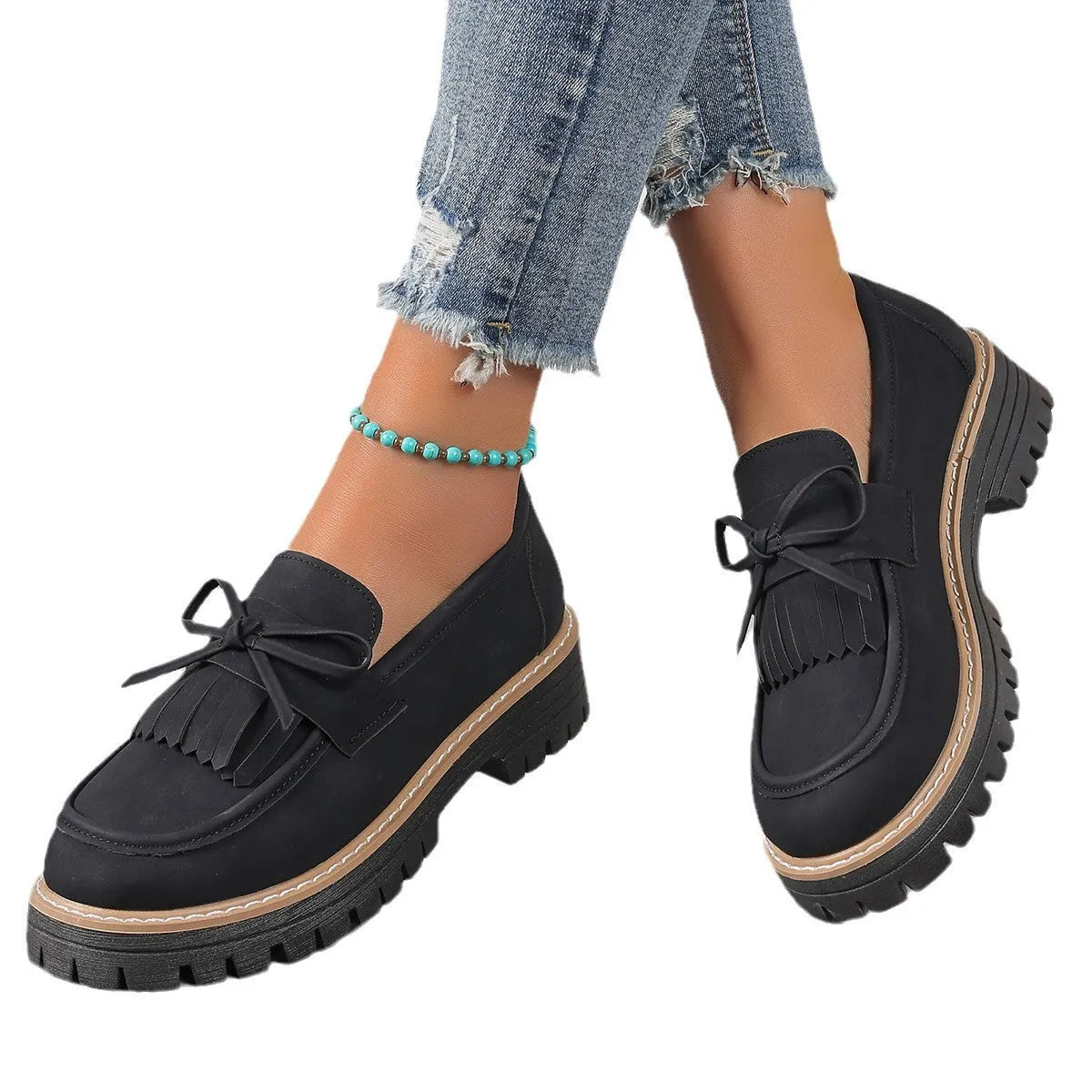 Women's black plus size loafers with a bowknot, tassel, and chunky rubber sole.