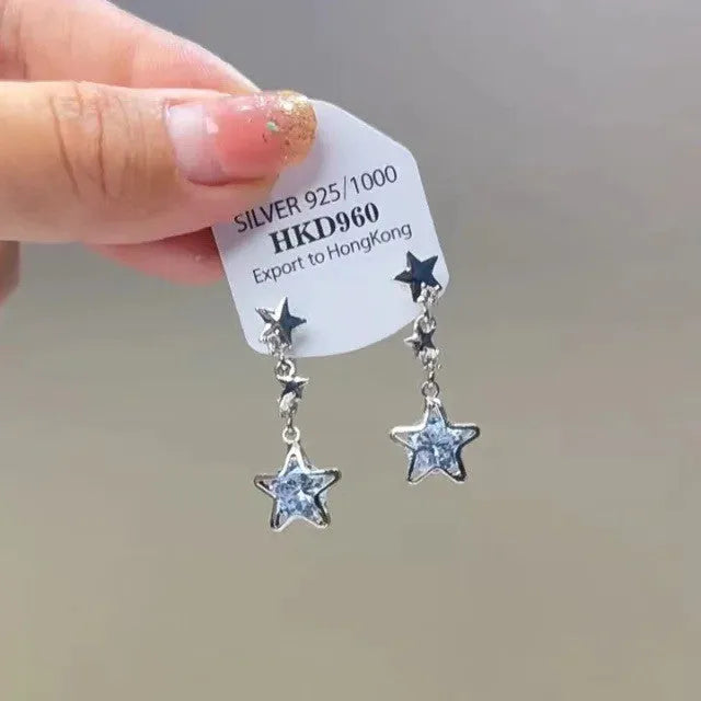 Geometric silver-tone alloy ear clips with rhinestones and hanging tassels, showing heart-shaped details