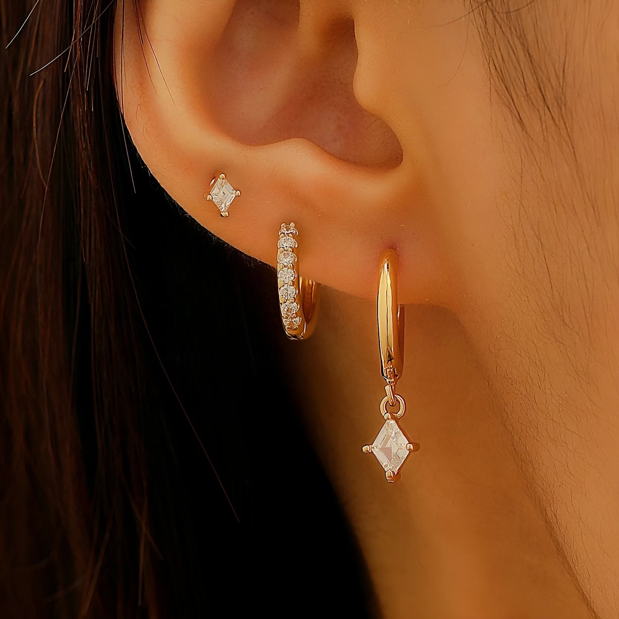 Geometric design copper jewellery set with zircon stones showing drop earrings, stud earrings and ear clips