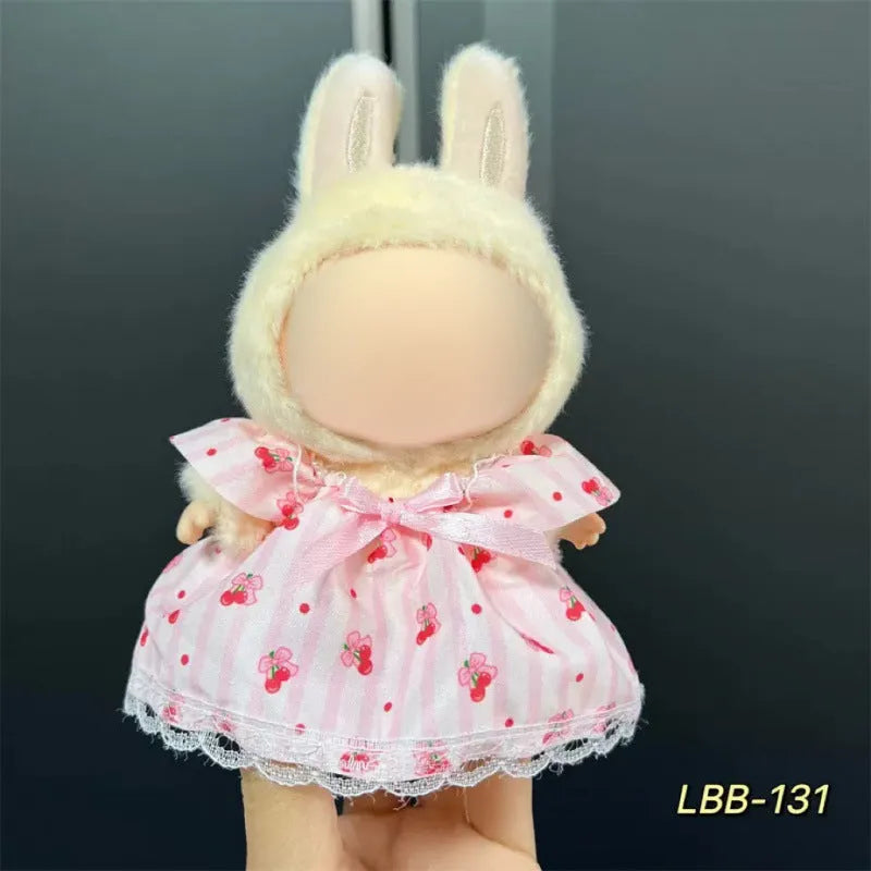 Plastic clothing outfit for a 17cm tall vinyl figure or doll on a display stand.