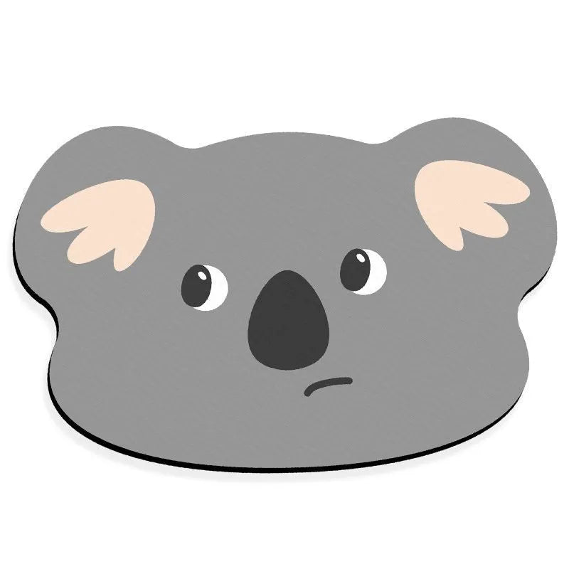Cute cartoon animal diatomaceous earth bath mat in alien shape on bathroom floor.