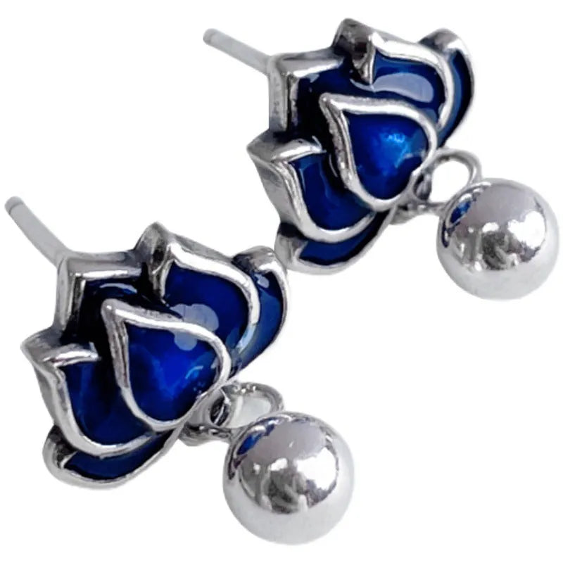 Blue lotus flower and seedpod tassel drop earrings with silver needle details on alloy studs.