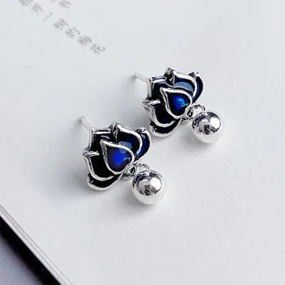 Blue lotus flower and seedpod tassel drop earrings with silver needle details on alloy studs.