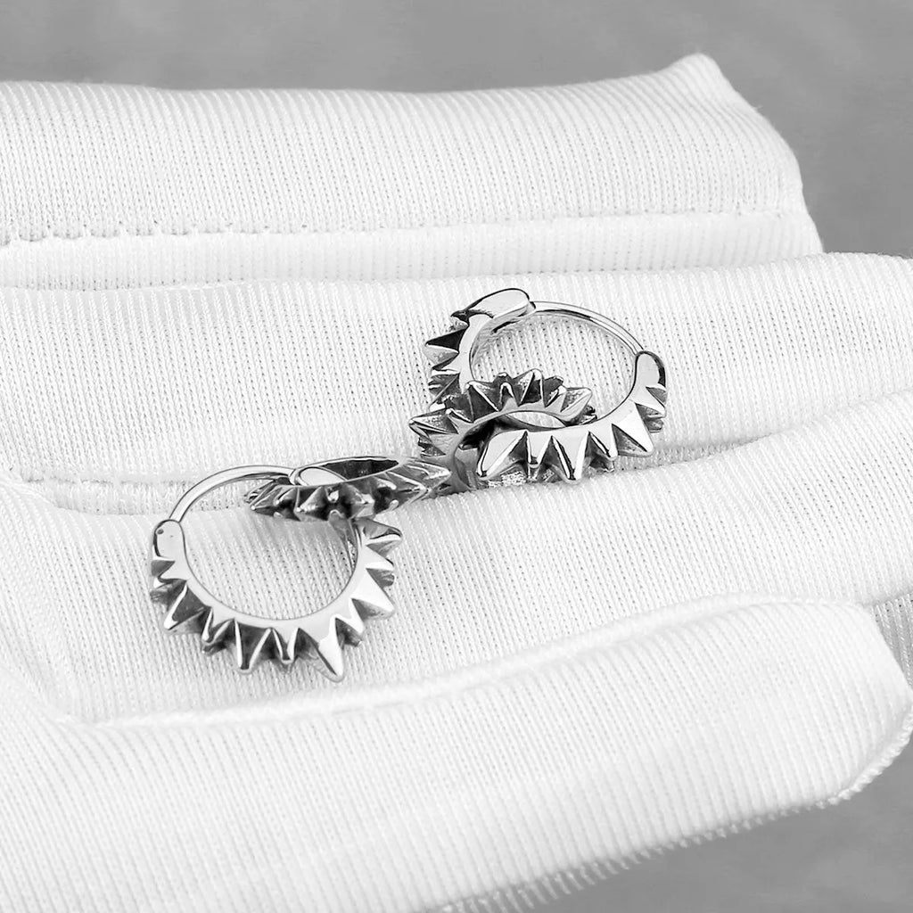A pair of simple stainless steel round hoop earrings with a polished finish.