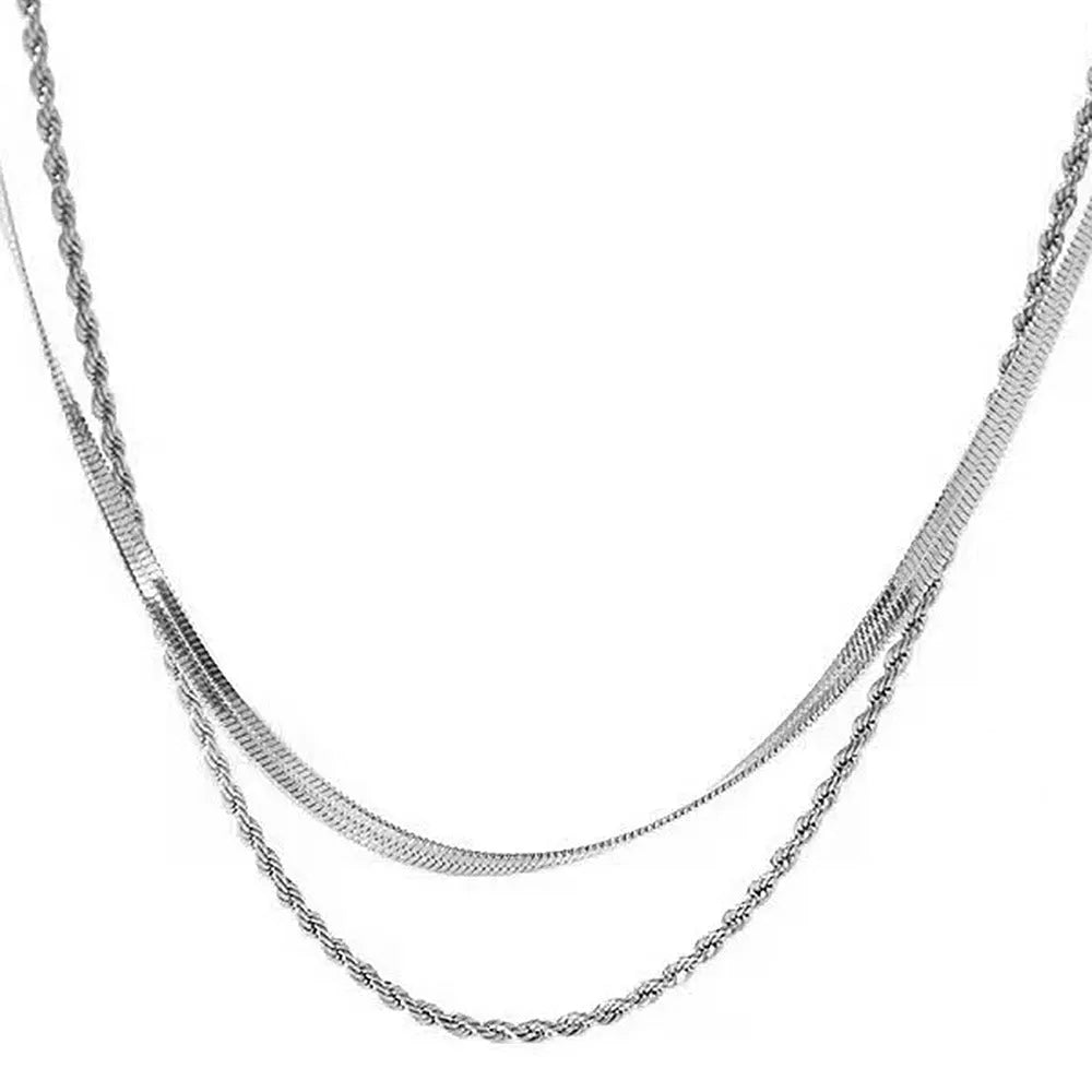 Women's geometric double-layer twist pendant necklace on an adjustable silver snake chain, shown at a mid-length setting.