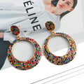 Large round pendant alloy earrings with colourful diamond cartoon design on a white background.