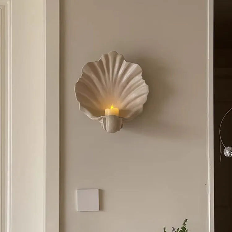 White resin fruit plate ornament shaped like a shell on a table