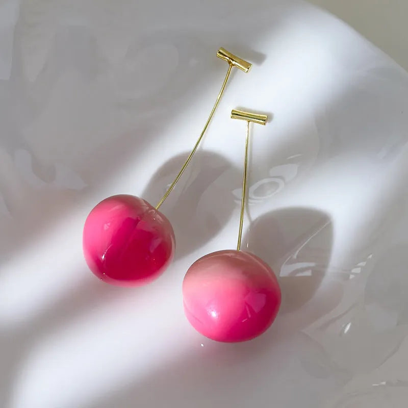 Acrylic peach fruit earrings with copper findings, shown in small and large size options.