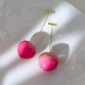 Acrylic peach fruit earrings with copper findings, shown in small and large size options.