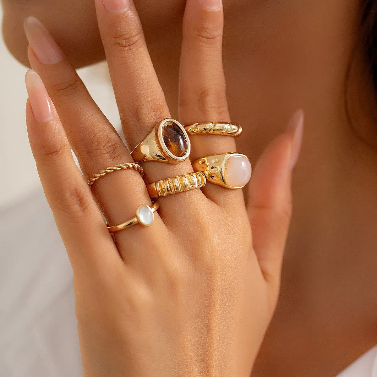 Six irregular geometric alloy rings in light gold electroplated finish arranged as jewellery set