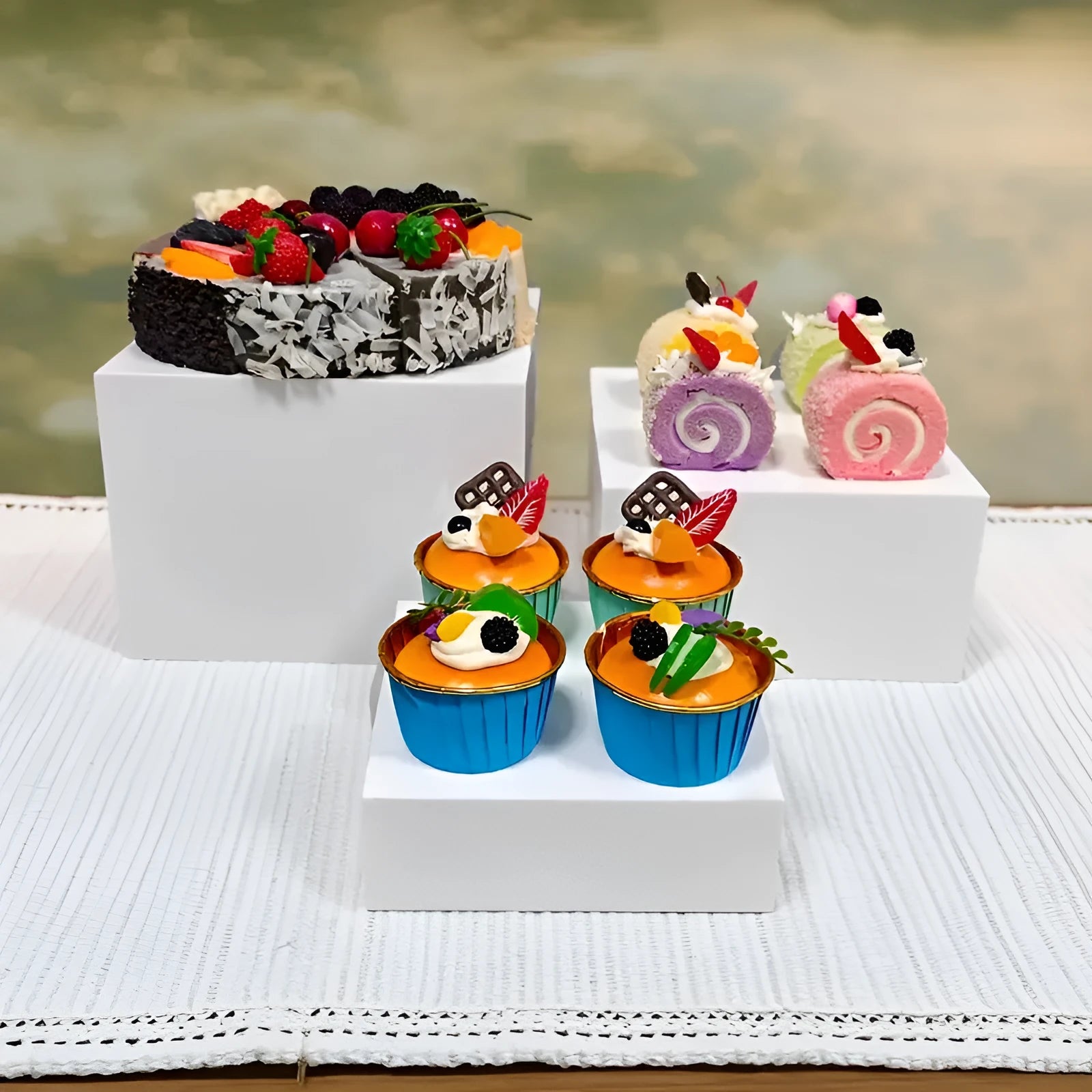 White plastic modular dessert display stand cubes stacked to form a tiered tabletop cake stand.