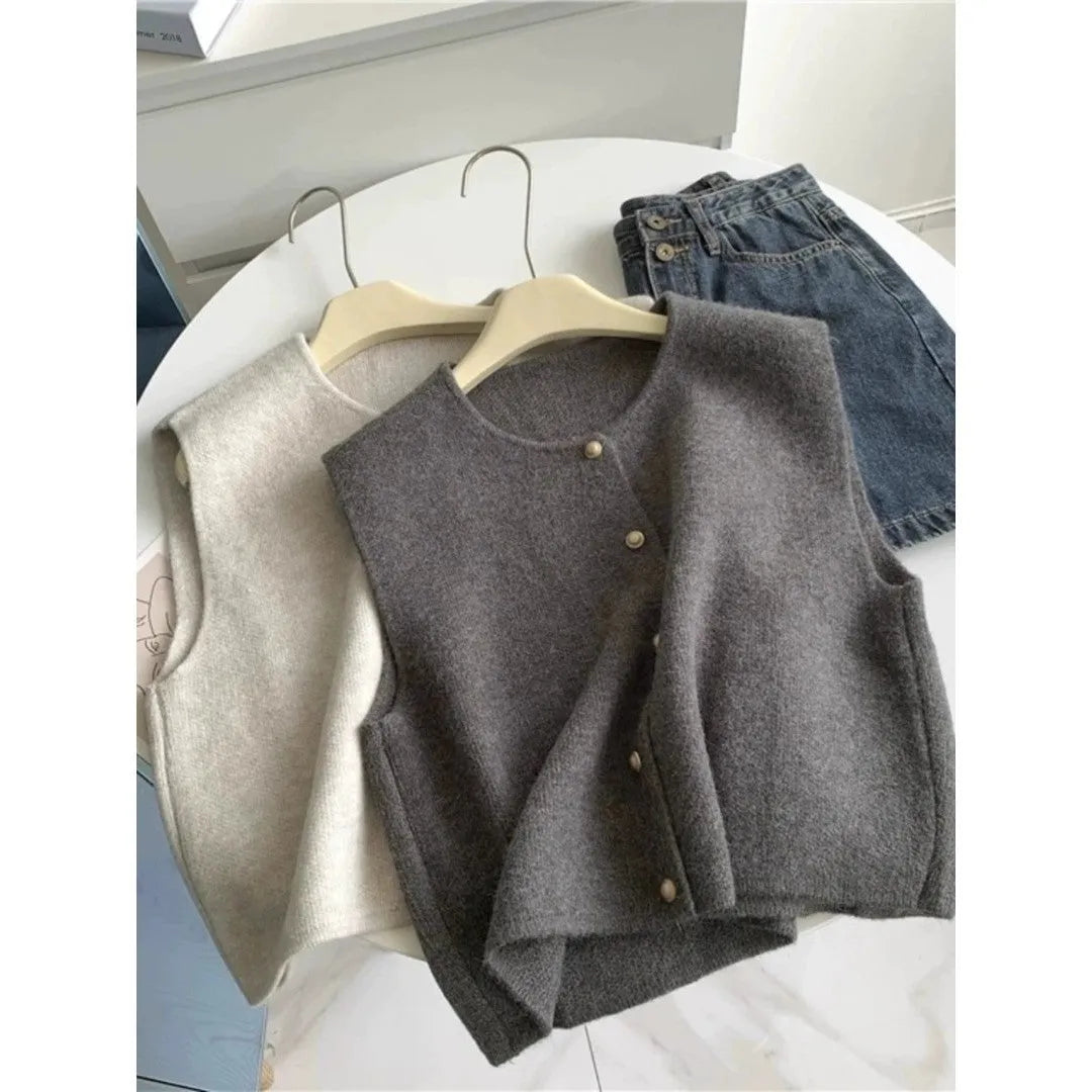 Thin polyester pullover vest with half sleeves in various colours on a hanger