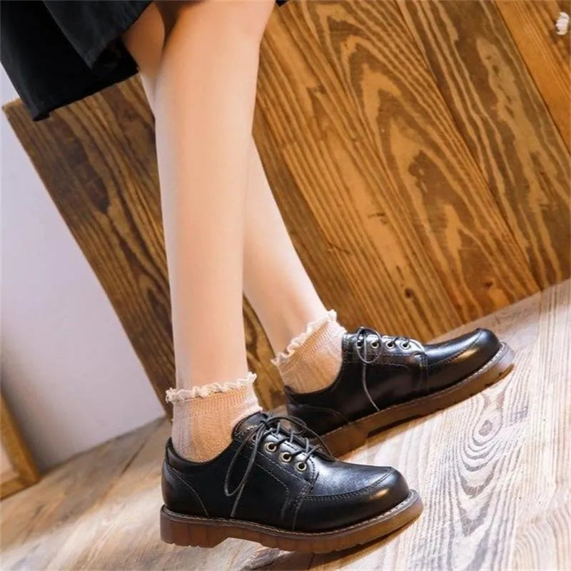 Women's black preppy retro Mary Jane shoes with round toe and front lace-up.