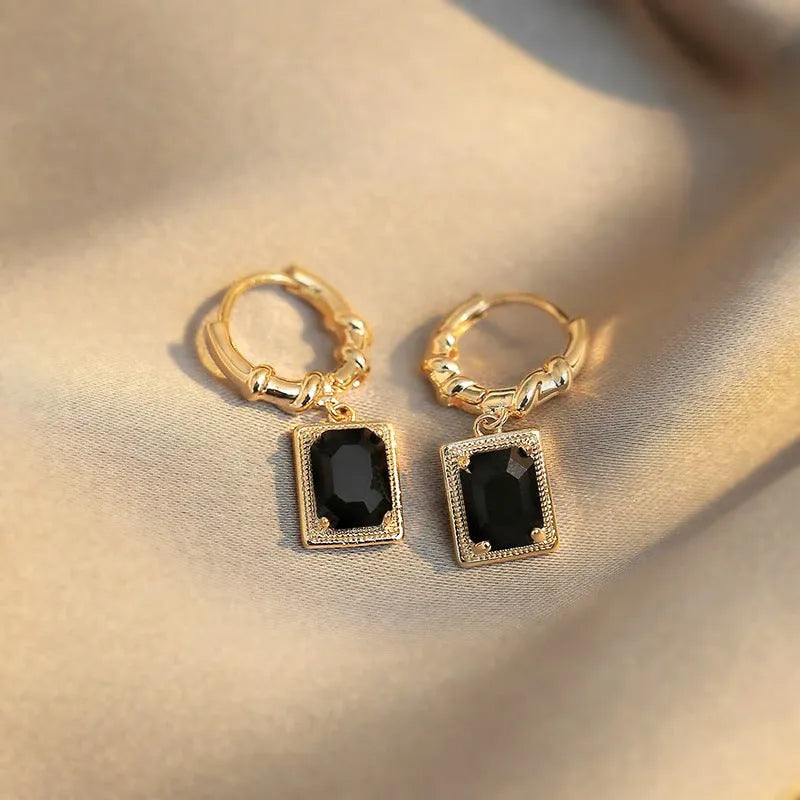 A pair of black geometric quadrilateral earrings with zircon stones on copper in a retro French court style.