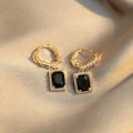 A pair of black geometric quadrilateral earrings with zircon stones on copper in a retro French court style.