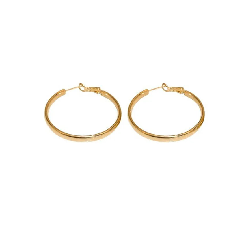 A pair of gold-coloured metal circle hoop earrings on a 40mm diameter.