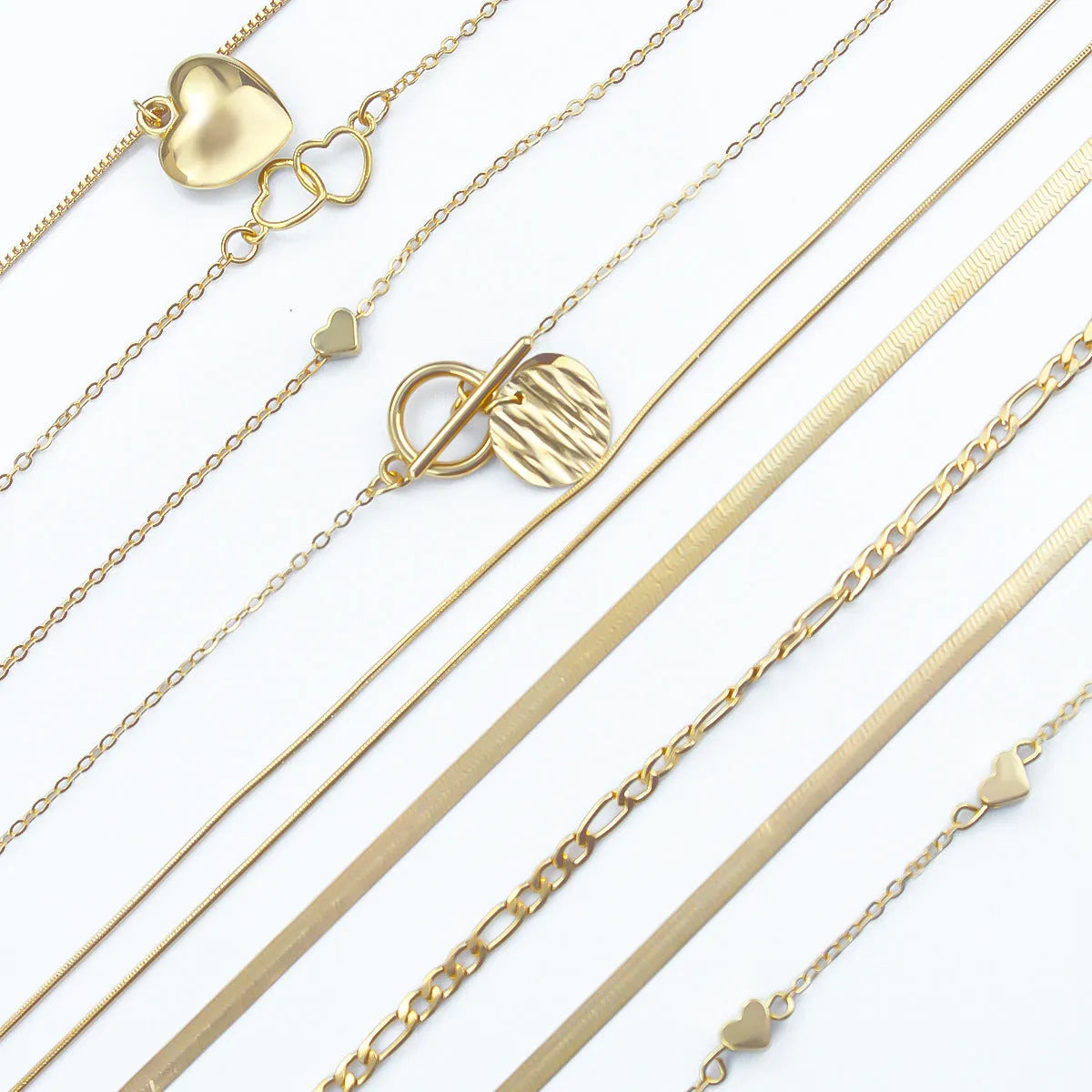 Ten gold necklaces with snake bone chains and alloy pendants displayed as complete jewellery set