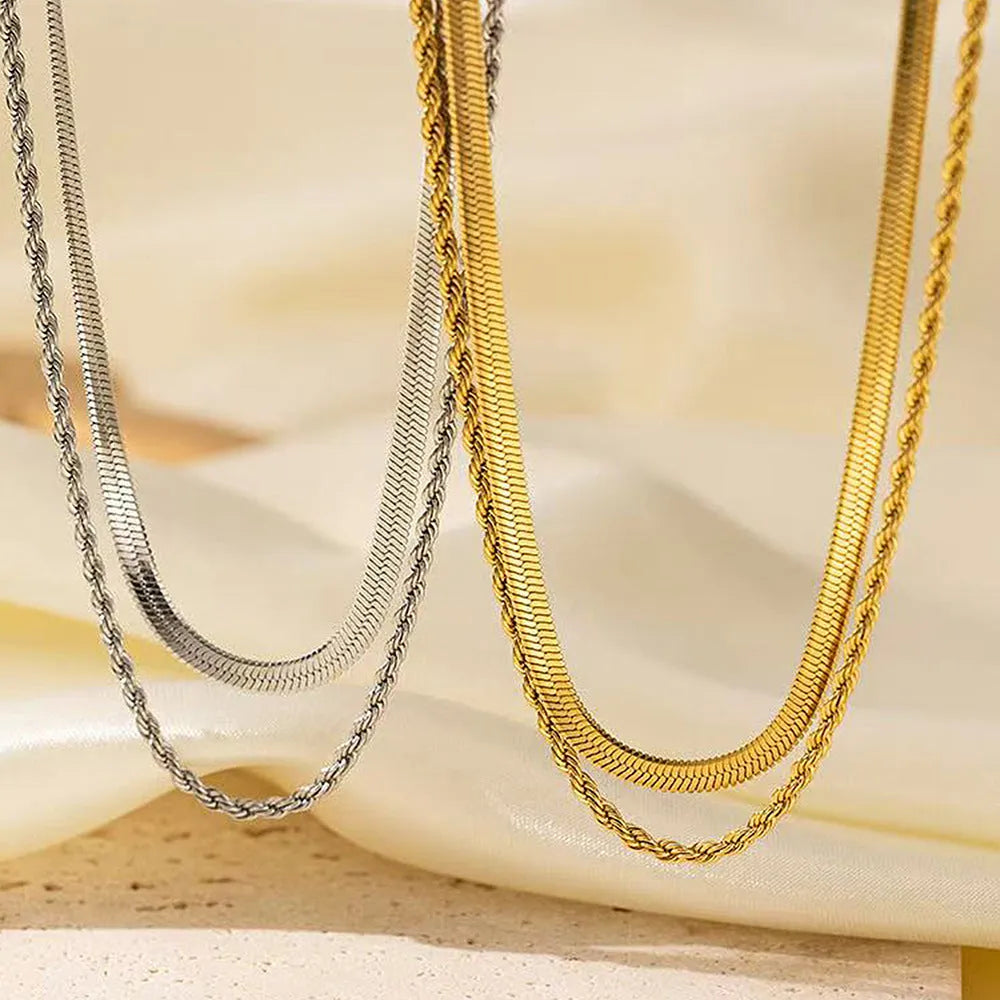 Women's geometric double-layer twist pendant necklace on an adjustable silver snake chain, shown at a mid-length setting.