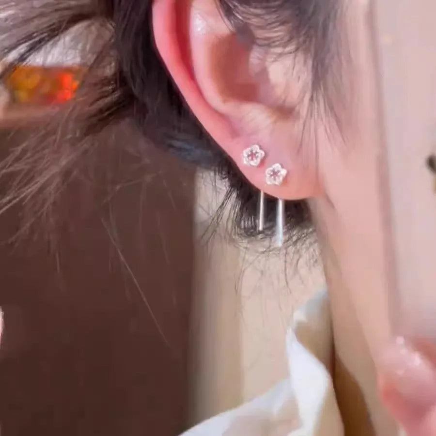Sterling silver hollow flower drop earrings with needle posts and petal detailing
