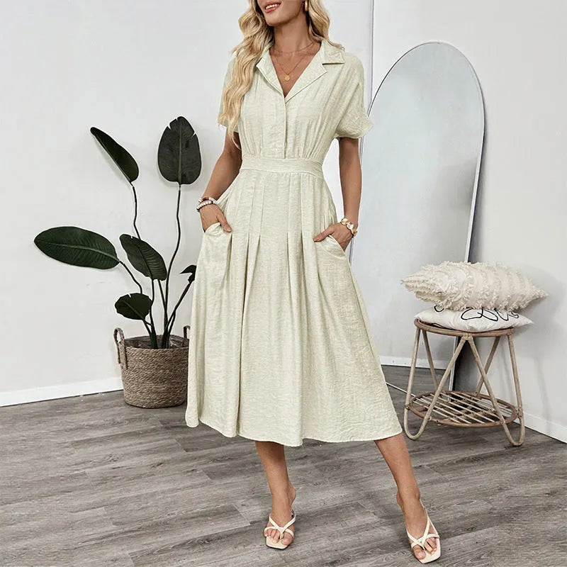 Light green commuter shirt dress with lapel collar, waist tie, and side pockets on a hanger.
