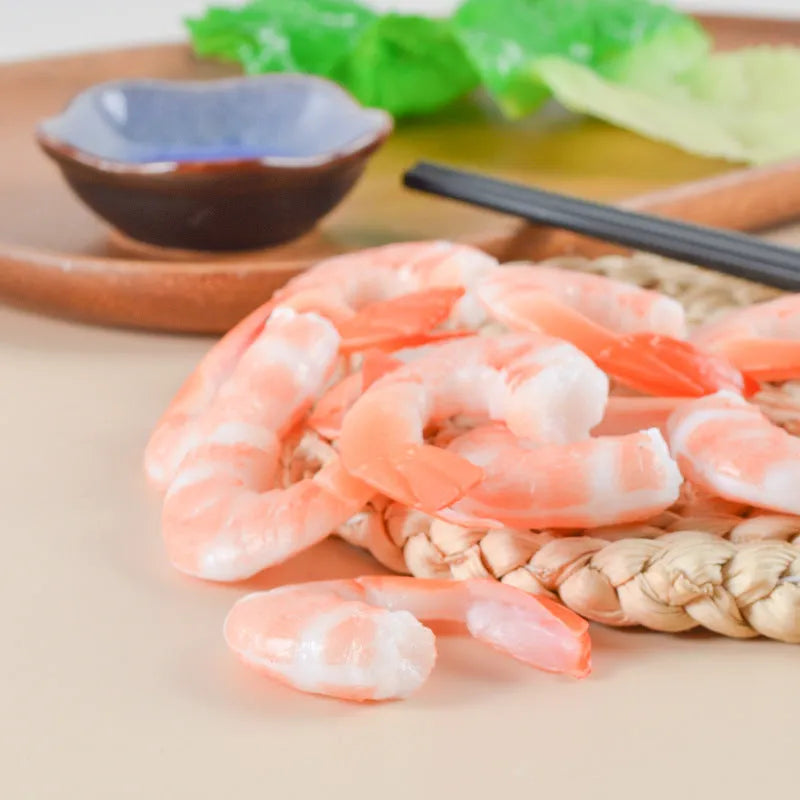 PVC injection moulded shrimp-shaped keychain with door buckle function, shown in modern simplicity style.