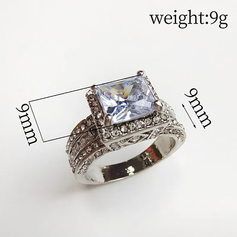 Close-up of a geometric round silver-tone women's ring with a polished electroplated finish, shown in gold and white colour options.