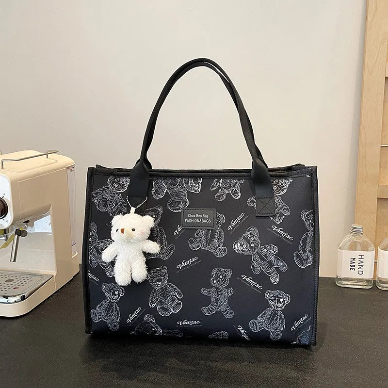 Women's printed canvas tote bag with rhombus pattern showing horizontal square shape and shoulder strap
