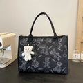Women's printed canvas tote bag with rhombus pattern showing horizontal square shape and shoulder strap