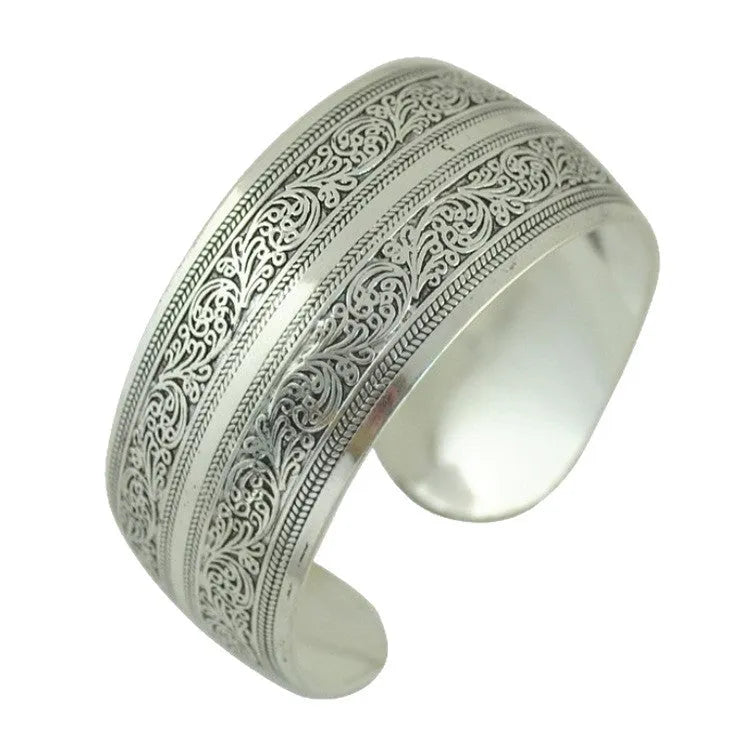 Miao ethnic silver-style bracelet with carved open design in alloy construction
