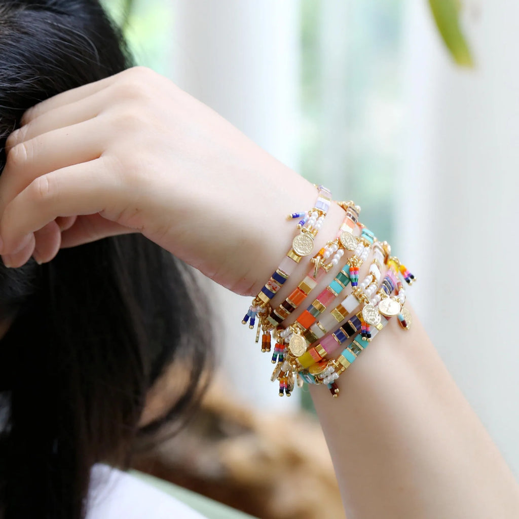 Women's handmade bracelet with glass coloured imitation pearl beads on wrist, showing one of six available colour styles.
