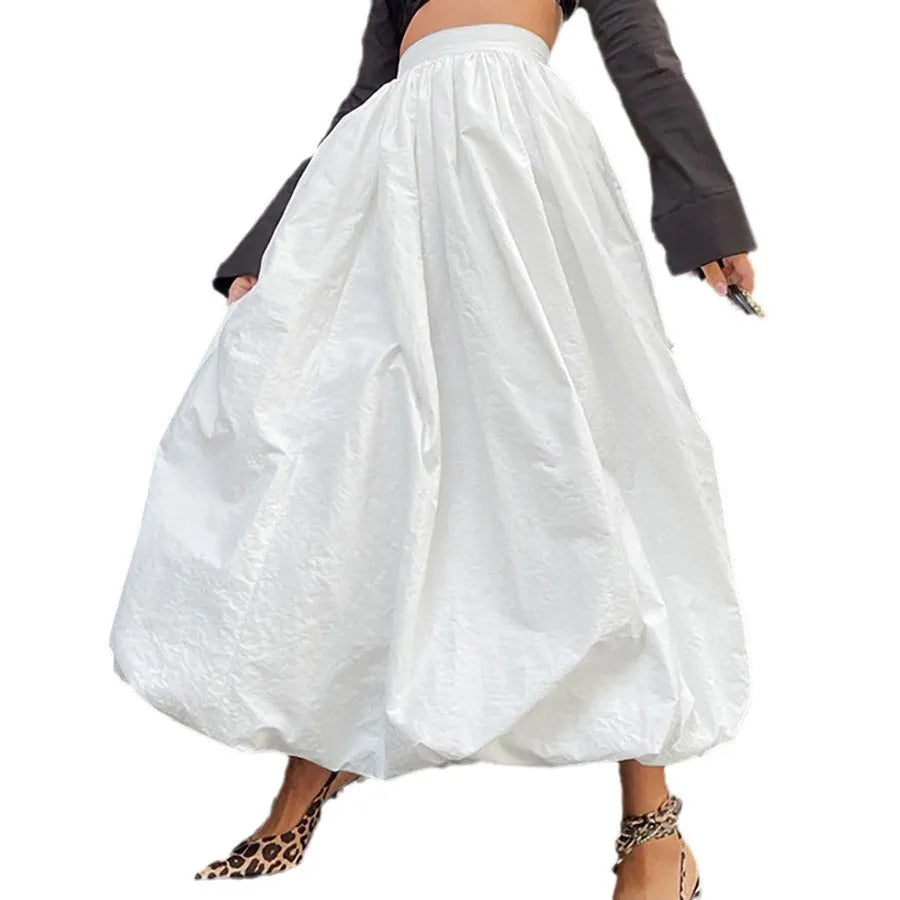 Women's solid colour long cotton skirt on a hanger, available in black and white.