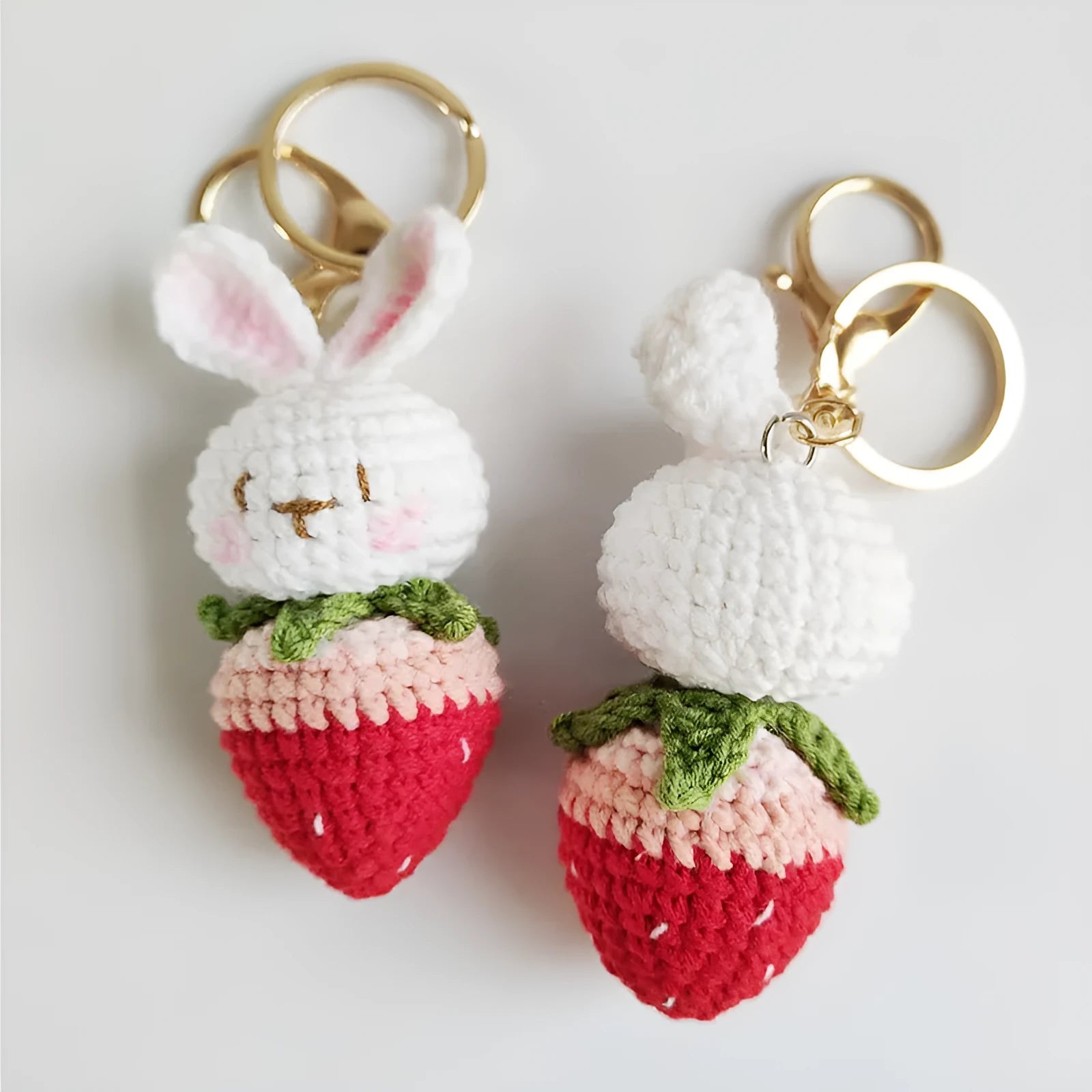 Hand-woven white rabbit strawberry cartoon charm pendant with a key attached